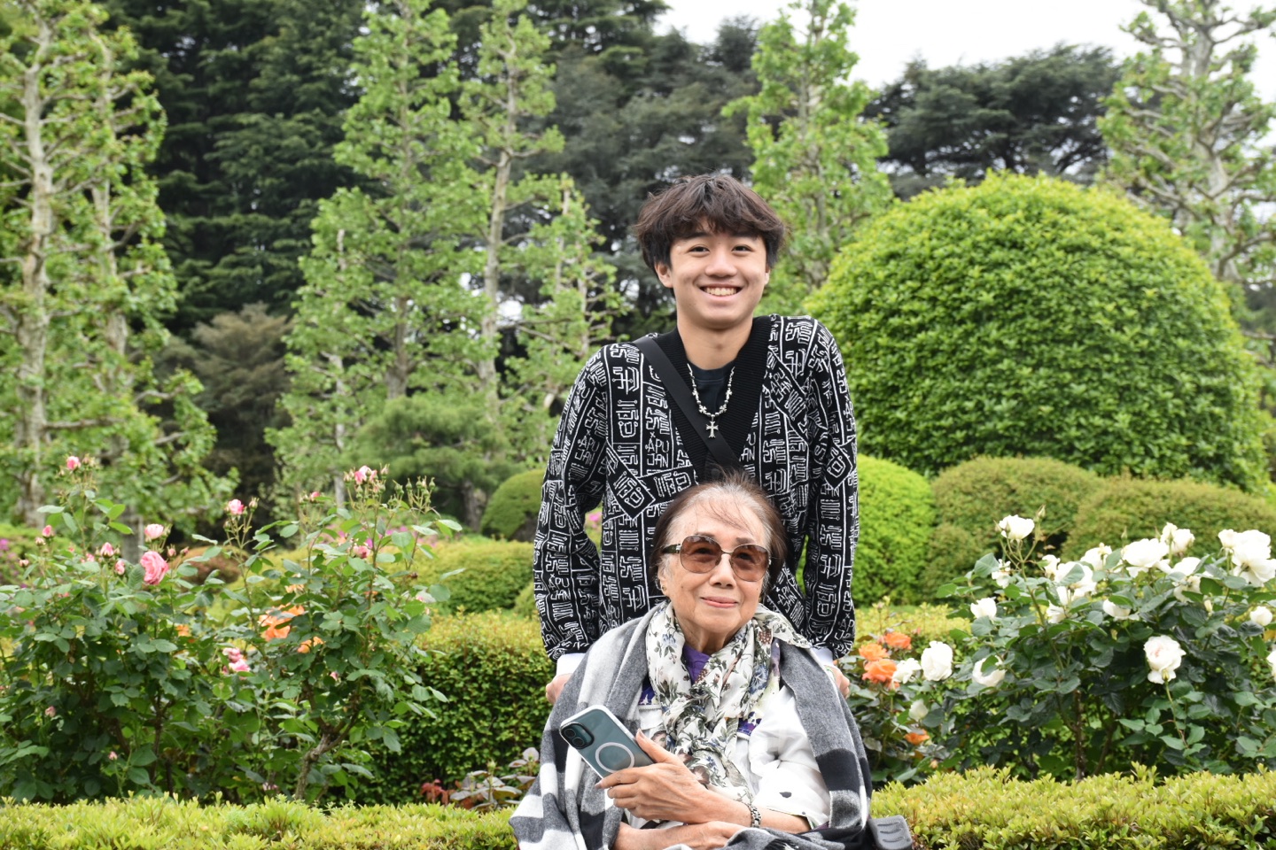 A wheelchair traveller and her companion visiting a garden in Tokyo.